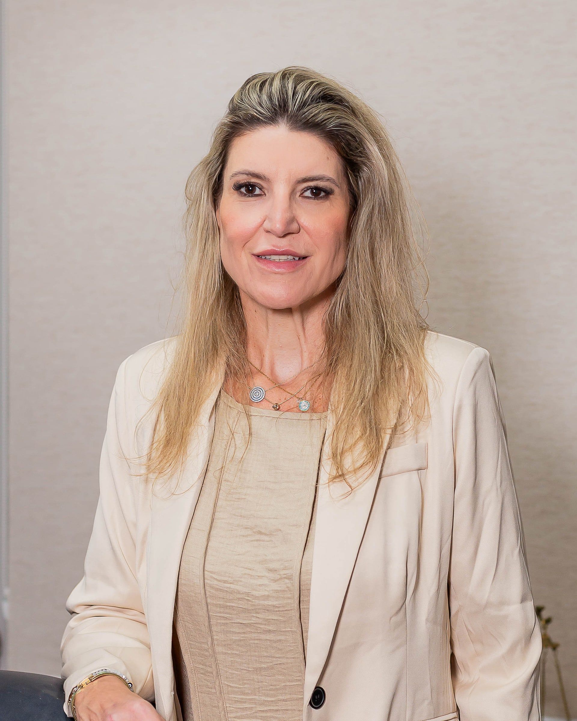 Elisa Backes, de blazer claro, em sala do escritório Backes Advogados
